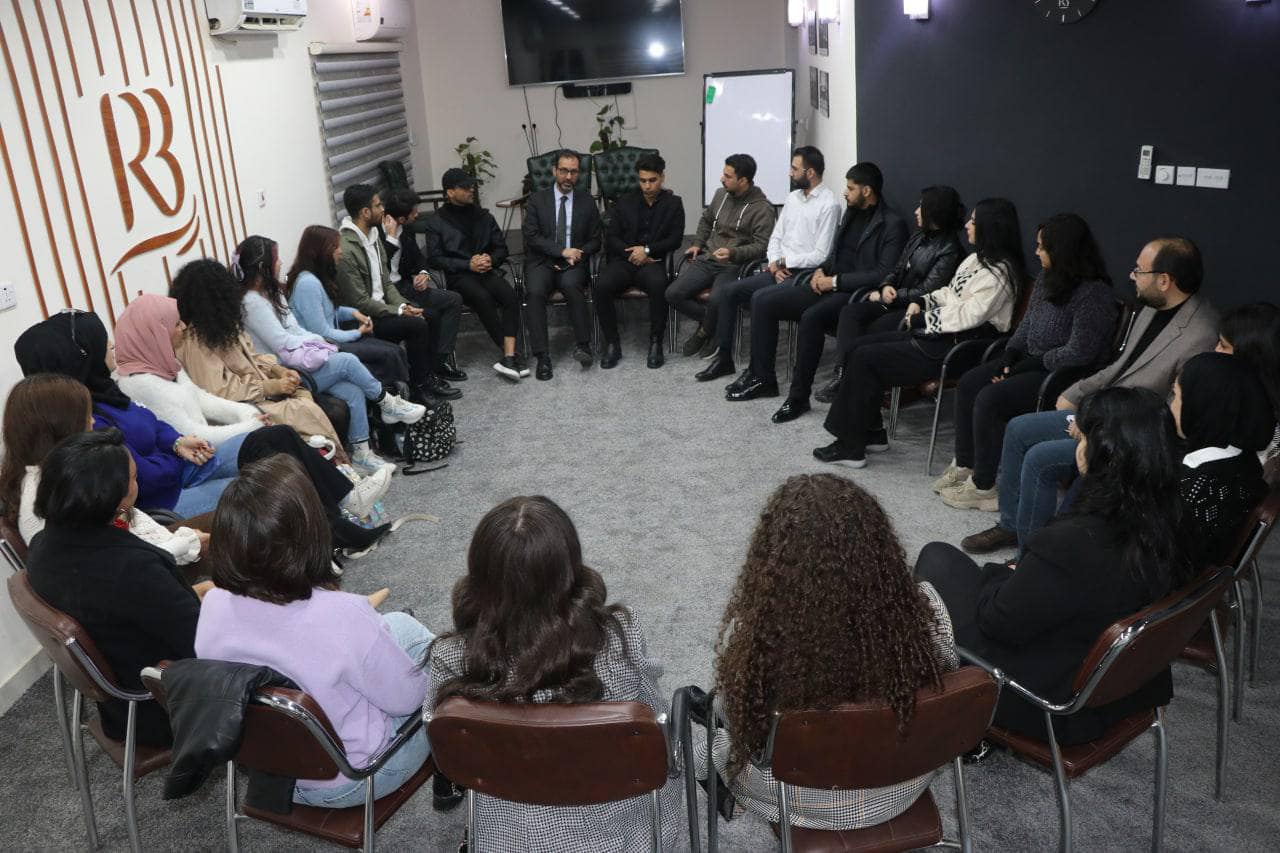 head of Rewaq Baghdad Center for Public Policy, MR. Abbas Al-Anbouri, awards a group of students from the Translation Department at Al-Mustansiriya University certificates of appreciation.